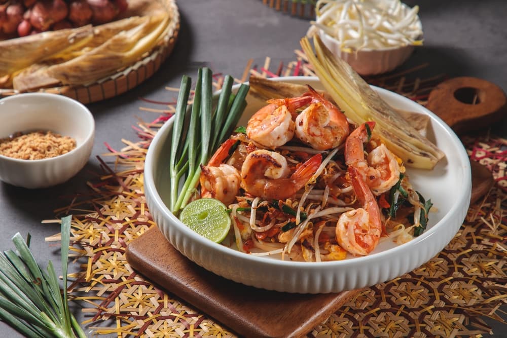 A plate of pad thai, with flavor and ingredients that exemplify why Thai food is popular.