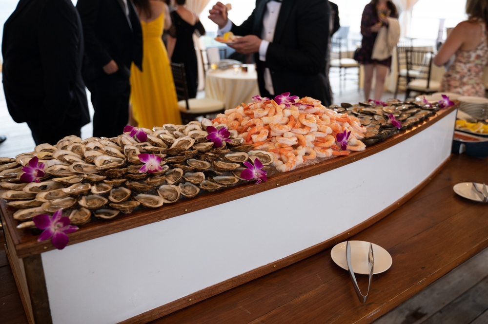 raw bar seafood boat with oysters and prawns at a buffet