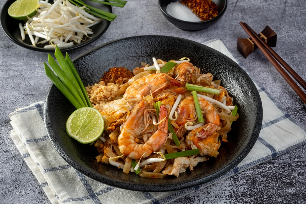 A plate of Pad Thai, arguably the most well-known of Thai noodle dishes.